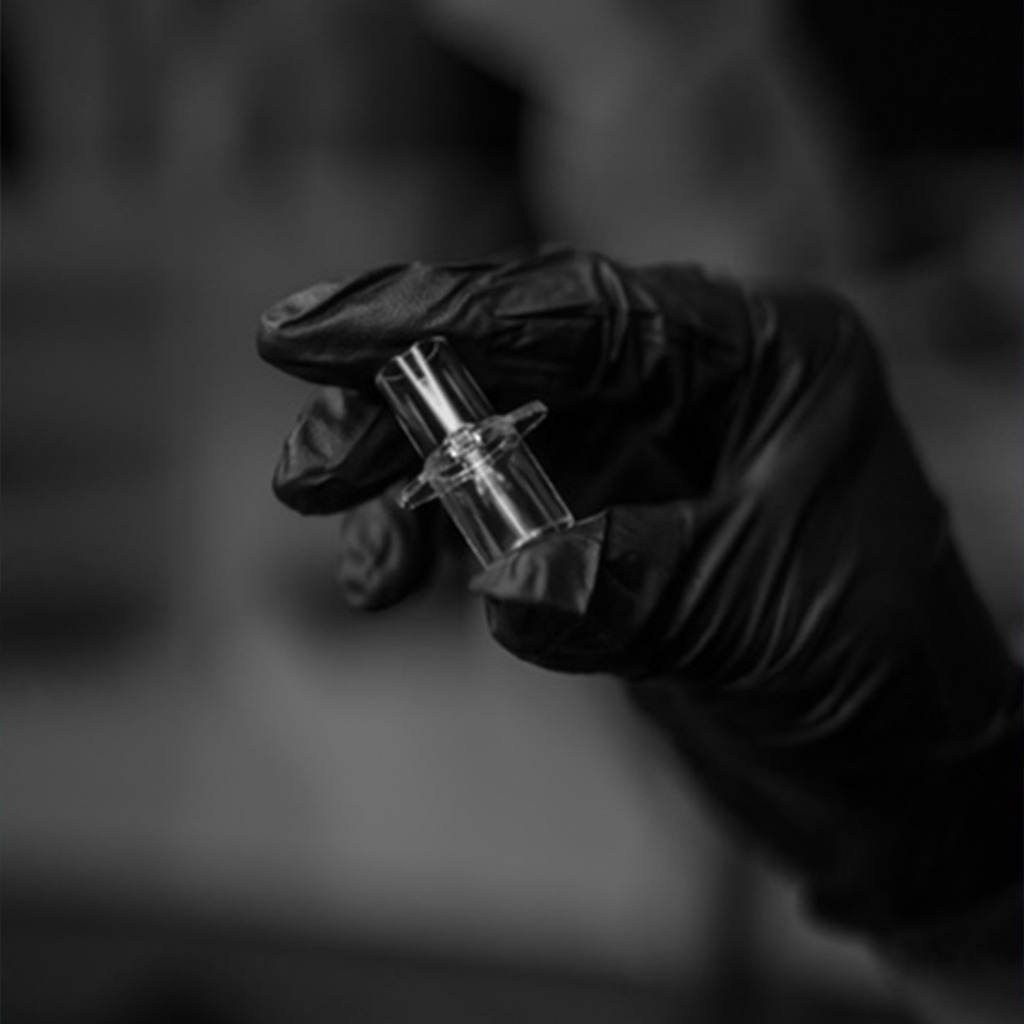 A Black and White Photo Showing a Person Holding a Glass Tube in Their Hand